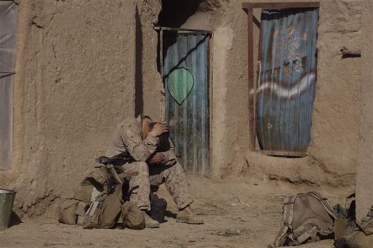 A U.S. Marine from 3rd Battalion, 6th Marine Regiment sits alone after a patrol in Marjah in Afghanistan's Helmand province Friday, Feb. 19, 2010. (AP Photo/David Guttenfelder)