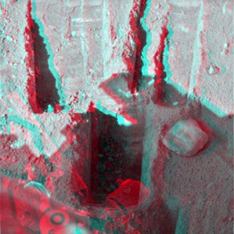 Stone Soup is in the center foreground of this stereo view, which appears three dimensional when seen through red-blue glasses. The view combines left-eye and right-eye images taken by the lander's Surface Stereo Imager on Sol 88 after the day's digging. The trench is about 25 centimeters (10 inches) wide and about 18 centimeters (7 inches) deep. Credit: NASA/JPL-Caltech/University of Arizona/Texas A&M University