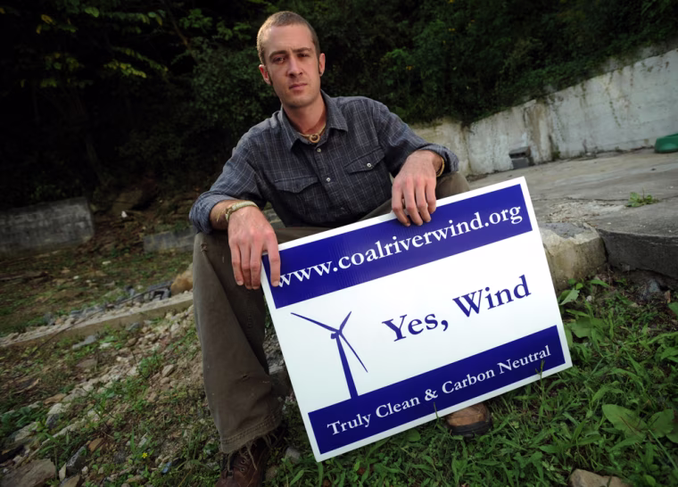 **ADVANCE FOR WEEKEND EDITIONS OCT. 25-26** Rory McIlmoil , an organizer with Coal River Mountain watch holds a sign in support of wind turbine energy, Friday, Sept. 19, 2008 in Whitesville, W.Va. (AP Photo/ Jeff Gentner)