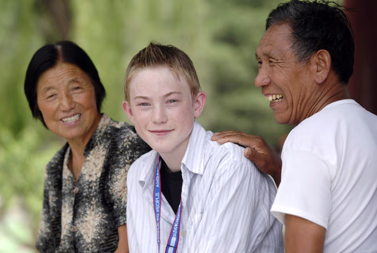 Image: Young traveler with locals in Beijing