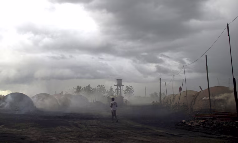 Image: A man walks past charcoal kilns in Tailandia, state of Para, Brazil