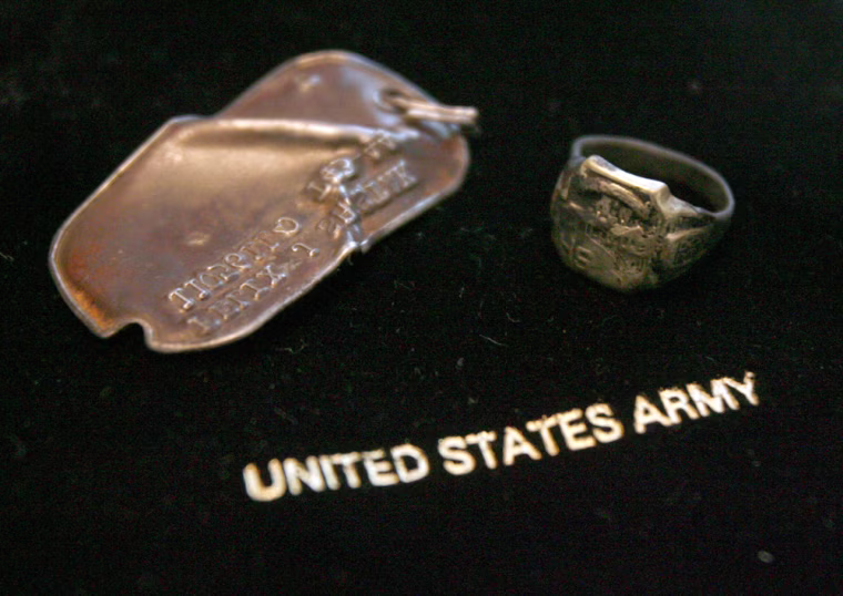 ** CORRECTS WHO FOUND THE DOG TAGS AND RING ** A dog tag and high school class ring that belonged to Felix Shostak are seen in Proctor, Vt., Thursday, July 10, 2008. In 1944, Felix Shostak was a crew member on a B-24 bomber that was shot down over France. His remains were never found. But recently, crash site investigators found Shostak's dog tags and his class ring, which have since been returned to Shostak's brother Charles. (AP Photo/Toby Talbot)