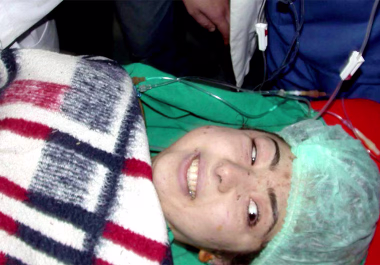 Turkish woman, 24-year old Yasemin Yaprakci smiles in an ambulance after she was pulled out alive from the rubble of a collapsed apartment building in Konya, central Turkey, Monday, Feb. 9, 2004, seven days after the building collapsed.   Rescue workers spent hours working to free her feet which were trapped under bodies. Her condition is reported to be serious. (AP Photo/Bostan Cemiloglu/Cihan) ** TURKEY OUT **