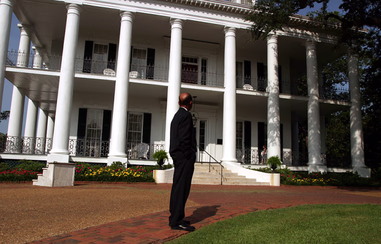 Mayor West looks at the Dunleith, one of Natchez's beautifully restored plantation homes. He has made it a priority to ask the owners of the city’s antebellum mansions -- Natchez’s top tourist attraction -- to present a balanced picture of plantation life. Black leaders have long found fault with many of the historic showcases, charging that they present an idealized version of the Old South that minimizes the horrors of slavery.