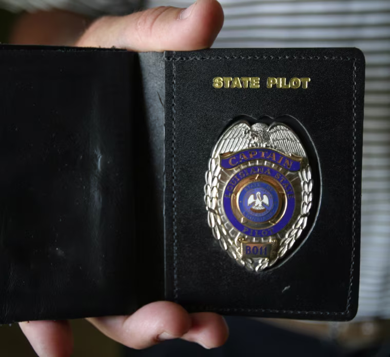 IMAGE: BAR PILOT HOLDS BADGE