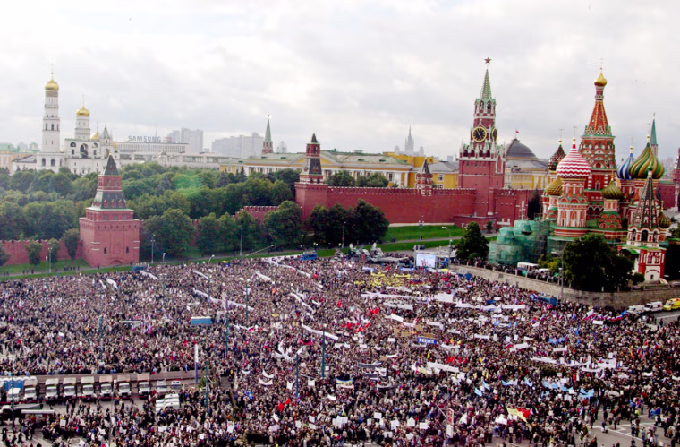Demonstrators rally against terrorism  in the area next to St.Basil's Cathedral, right, on Red Square in Moscow, Tuesday, Sept. 7, 2004. Tens of thousands of Russians massed outside the Kremlin for a rally against terrorism Tuesday, responding to government calls for unity after a series of deadly attacks while mourners in Beslan lowered caskets into the damp earth at a cemetery burgeoning with victims of a school siege that claimed more than 350 lives. (AP Photo/Mikhail Metzel)