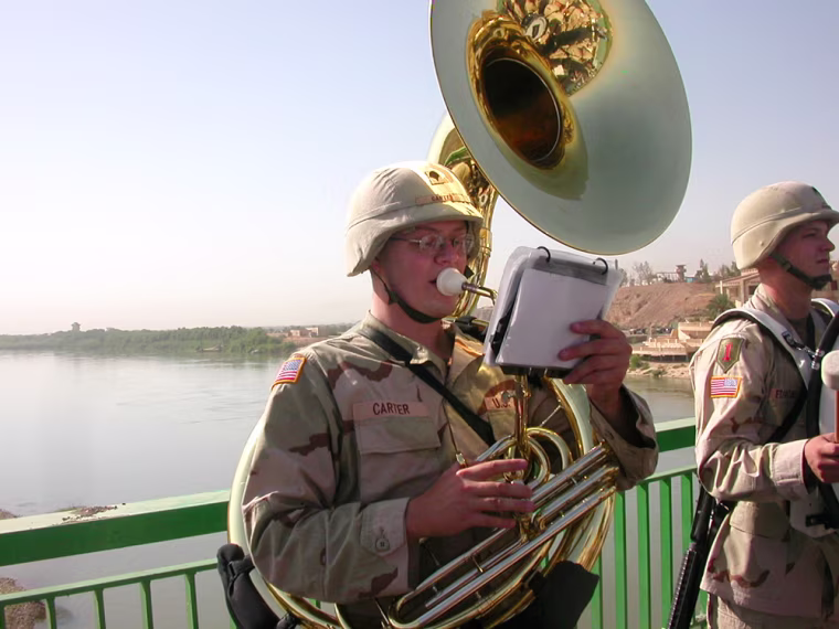The Bridge--a vital link between and the northern Iraqi city of Kirkuk, reopened on Wednesday after a $5.4-million U.S. funded reconstruction project to repair damage from American warplanes last year. CAPTION: A member of the Army's 1st Infrantry Division band pumps out the Iraqi national anthem to mark the start of a ceremony. CREDIT: Jackie Spinner / TWP. Downloaded e-mail 09/21/2004 jap