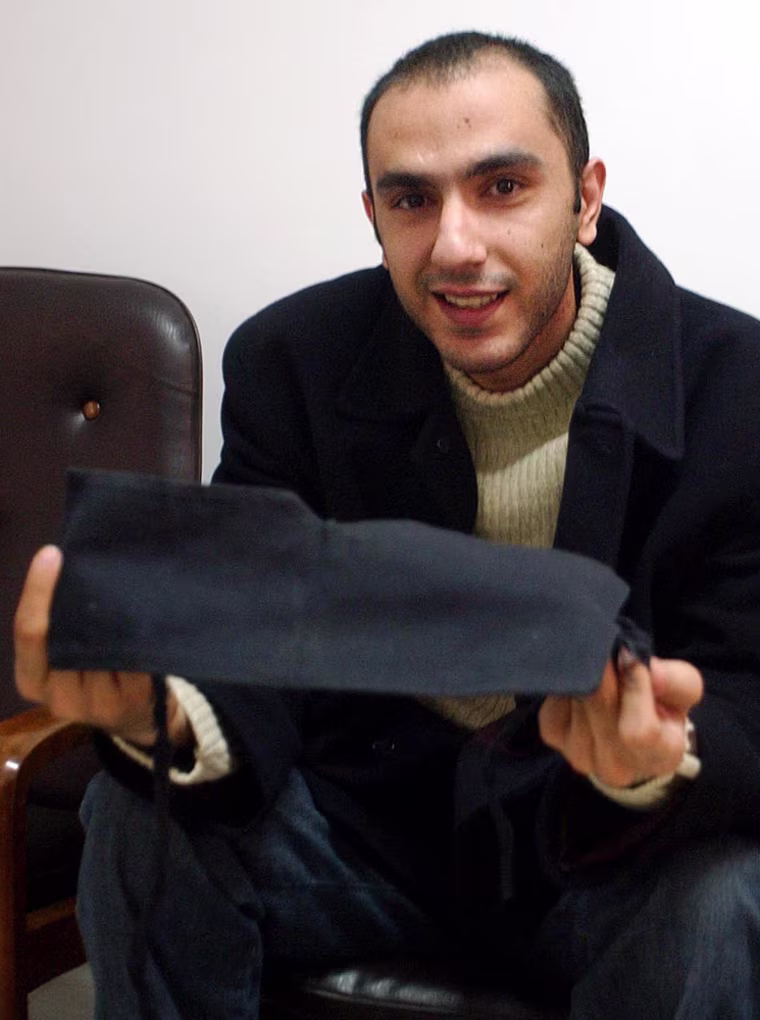 Web blogger Hanif Mazrouei, one of more than 20 journalists detained since a new crackdown on pro-reform Iranian media was launched in September, shows the blindfold he was made to wear for most of the 66 days he was kept in solitary confinement, during an interview with The Associated Press, in Tehran, Iran, Tuesday, Jan. 11, 2005. My interrogator punched me in the head and stomach and kicked me in the back many times to force me confess to having illegal sex and endangered national security through my writings, Mazrouei said. (AP Photo/Vahid Salemi)