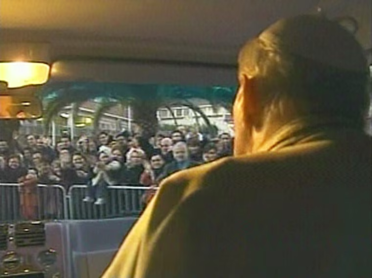 Crowds cheer Pope John Paul II, right, as he rides in a van through Rome on Sunday.