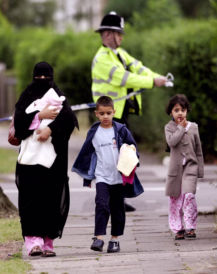 Residents are evacuated as a house is searched in connection with investigations into the London bombings in Birmingham in central England