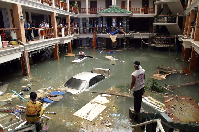 ** FOR USE AS DESIRED WITH YEAR END--FILE **Rescue and clean-up crew survey a flooded lobby at the Seapearl Beach Hotel along Patong Beach on Phuket Island, Thailand, in this Dec. 28, 2004, file photo, after massive tsunami waves smashed coastlines. The total toll of dead and missing from last year's Indian Ocean tsunami is at least 216,858, according to government and aid agency figures, although different agencies in Indonesia and Sri Lanka are reporting different numbers. (AP Photo/ CP, Deddeda Stemler)