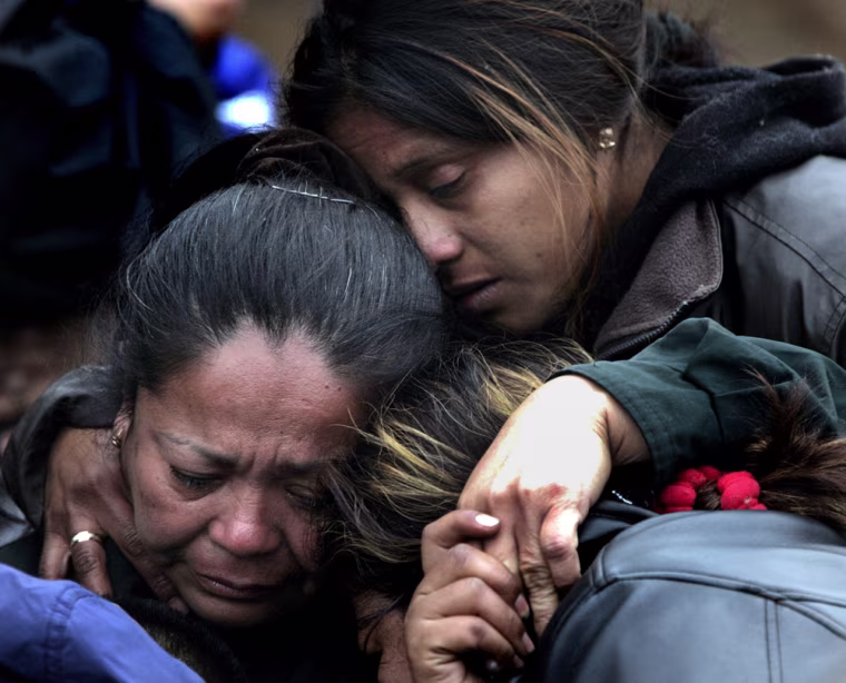 Relatives of trapped miners comfort each other after mine officials briefed friends and family outside of the Pasta de Conchas No. 8 coal mine in San Juan de Sabinas, Mexico, Tuesday,  Feb. 21, 2006. Digging to reach 65 miners trapped more than a mile undergound after a gas explosion has slowed due to poor air quality in the tunnel.  (AP Photo/LM Otero)