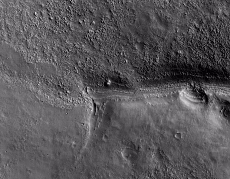 This view shows a full-resolution portion of the first image of Mars taken by the High Resolution Imaging Science Experiment camera (HiRISE) on NASA's Mars Reconnaissance Orbiter. The spacecraft, launched Aug. 12, 2005, began orbiting Mars on March 10, 2006. The image is of an area in Mars' mid-latitude southern highlands. 

HiRISE took this first test image from orbit on March 24, 2006, from an altitude of 2,489 kilometers (1,547 miles), achieving a resolution of 2.49 meters (98 inches) per pixel, or picture element. The smallest objects of discernable shape are about three pixels across. An image acquired at this latitude during the Mars Reconnaissance Orbiter's main science phase, beginning in fall 2006, would be taken from an altitude of about 280 kilometers (174 miles) and have a resolution of 28 centimeters (11 inches) per pixel. 

This view covers an area about 4.5 by 2.1 kilometers (1.6 by 1.3 miles), a subset of the broader image. (go to image) 

The quality of this test image is spectacular,