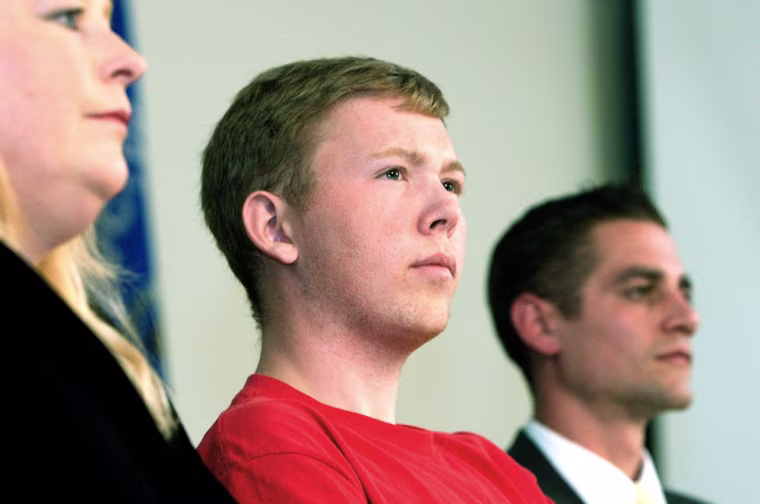 Green Bay East High School senior Matt Atkinson, center, sits during a news conference Wednesday, Sept. 20, 2006, in Green Bay, Wis., with his mother Nancy Dury, left, and Assistant Principal Matt Mineau. Atkinson said he was only doing the right thing when he told authorities his friends were planning a Columbine-like attack on the school last week. Atkinson told Mineau about the plan. (AP Photo/Press-Gazette, B.A. Rupert)