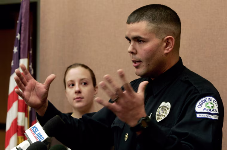 Ogden city police master officer Ken Hammond addresses the media Tuesday, Feb. 13, 2007, in Ogden.  Hammond, dressed in civilian clothes on his day off, confronted Sulejmen Talovic and returned fire as Talovic allegedly opened fired Monday night, killing 5 people, at a local shopping mall.  Talovic was killed by the police. Hammond's wife, Sarita, looks on. The two had dinner at a restaurant at the mall as a pre-Valentines Day date. (AP Photo/Douglas C. Pizac)