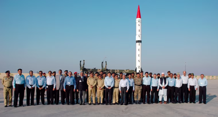 Pakistan's Chairman  of the Joint Chiefs of Staff Committee General Ehsan ul Haq (C) poses for a photograph with scientists and engineers before the launch of the nuclear capable Shaheen II, Hatf-VI missile