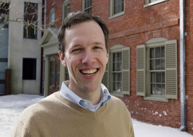 Steve Bromage, assistant director of the Maine Historical Society, poses Monday, Feb. 26, 2007, outside the Wadsworth-Longfellow House, in Portland, Maine. The Historical Society on Tuesday is hosting a 200th birthday celebration for Henry Wadsworth, one of the most beloved literary figures of 19th century America. The Wadsworth-Longfellow House is where the poet lived as a youth. (AP Photo/Joel Page)