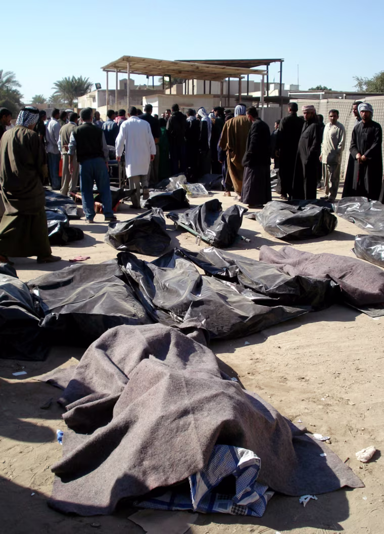 Bodies of victims of Tuesday's suicide bomber attacks are laid out on the ground in a hospital in Hillah, about 95 kilometers (60 miles) south of Baghdad, Iraq, Wednesday, March 7, 2007. Two suicide bombers turned a procession of Shiite pilgrims into a blood-drenched stampede, killing scores with a first blast and then claiming more lives among fleeing crowds. At least 106 people were killed amid a wave of deadly strikes against Shiites heading for a solemn religious ritual.  (AP Photo/Tahseen Ali)