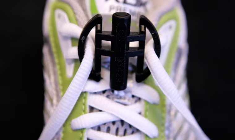 A small device shown in this March 30, 2007 photo, taken in Columbus, Ohio, contains computer chips that allows fans to monitor a runner on a race day Web site, get updates by cell phone text message or wait for e-mails to arrive. (AP Photo/Kiichiro Sato)