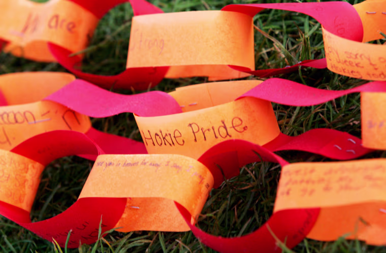 Paper prayer chains lie on the ground outside West Ambler Johnston Hall on the campus of Virginia Tech in Blacksburg, Va., Monday, April 23, 2007. Virginia Tech students made a somber return to campus Monday, pausing for a moment of silence to remember the classmates murdered a week ago in a gunman's rampage. (AP Photo/Mary Altaffer)