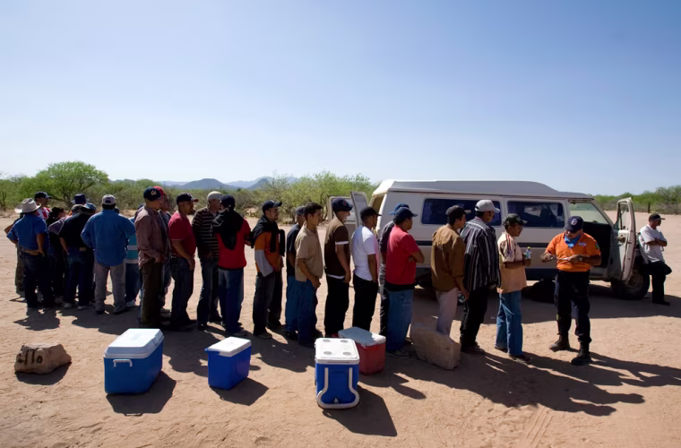 A group of migrants wait in line to give their names to a member of Mexico's government sponsored migrant assistance group, \"Grupo Beta\" in the Mexican town of El Tortugo, near the border with Arizona, Wednesday April 11, 2007. Mexican druglords, fighting back against increased U.S. border security, have seized control of coveted migrant-smuggling routes, collecting money and distracting National Guard and Border Patrol agents, Mexican and U.S. officials say.     (AP Photo/Eduardo Verdugo)