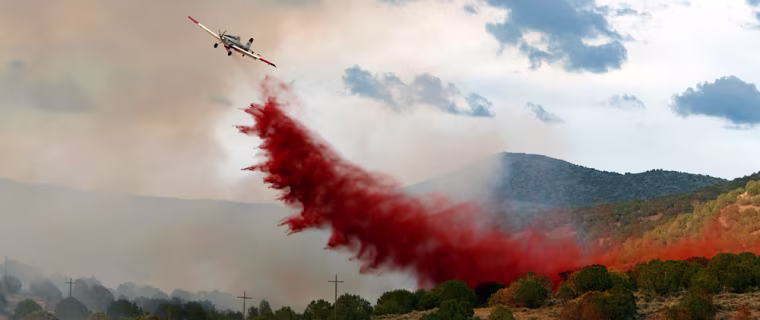 An air tanker drops retardant on the Salt Creek fire in Big Hallow Canyon outside Fountain Green, Utah Monday, July 23, 2007.  The Salt Creek fire has grown to over 18,000 acres and is still threatening several communities in the area.  (AP Photo/George Frey)