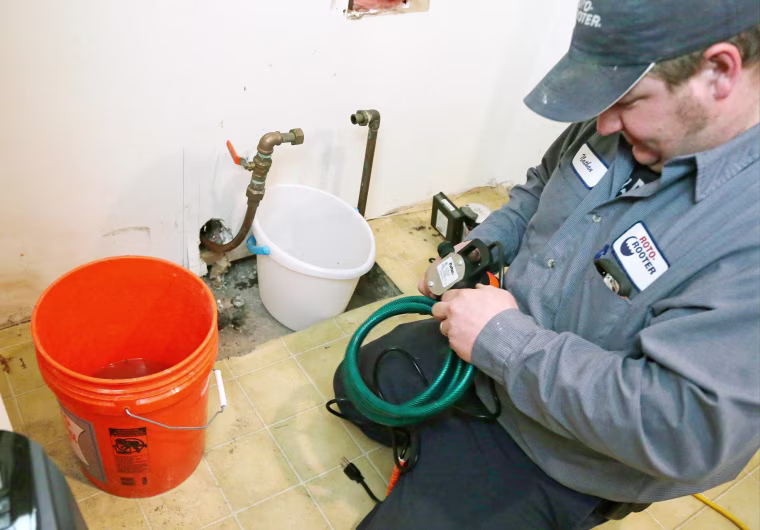 Image: A plumber prepares to work on a water pipe that was frozen in a south Minneapolis home.