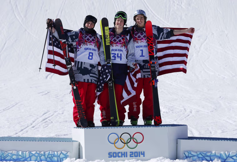 Image: U.S. finalists second placed Kenworthy, winner Christensen and third placed Goepper celebrate on podium after the men's freestyle skiing slopestyle finals at the 2014 Sochi Winter Olympic Games in Rosa Khutor