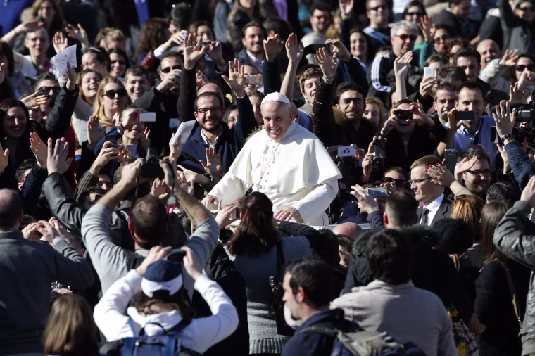 Image: Pope Francis leaves at the end of a special audience with engaged couple, to celebrate Saint Valentine's day, in Saint Peter