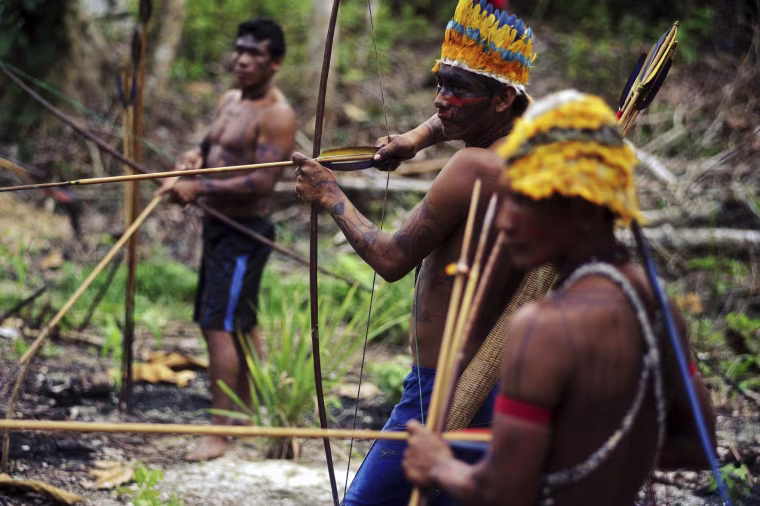 Image: Munduruku Indian warriors prepare themselves as they approach a wildcat gold mine in western Para state