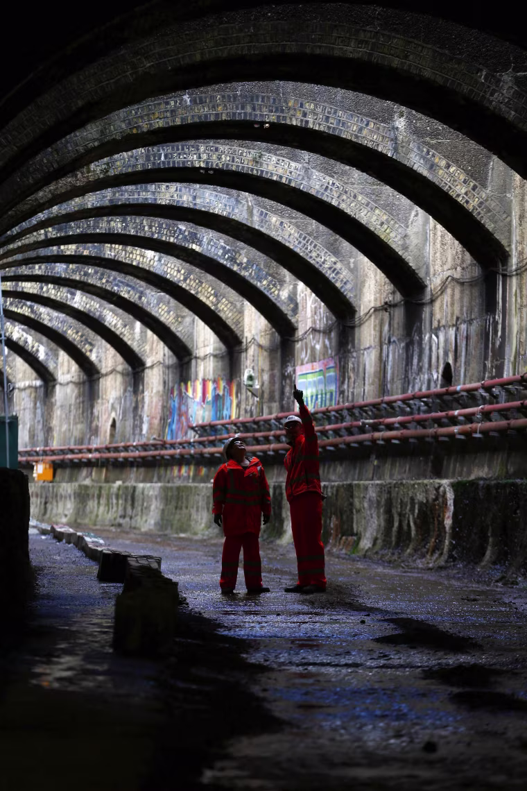 Image: Crossrail Project manager Linda Miller chats to Nick Mann of Crossrail as she poses in the entrance of the Connaught Tunnels section of their construction project in East London