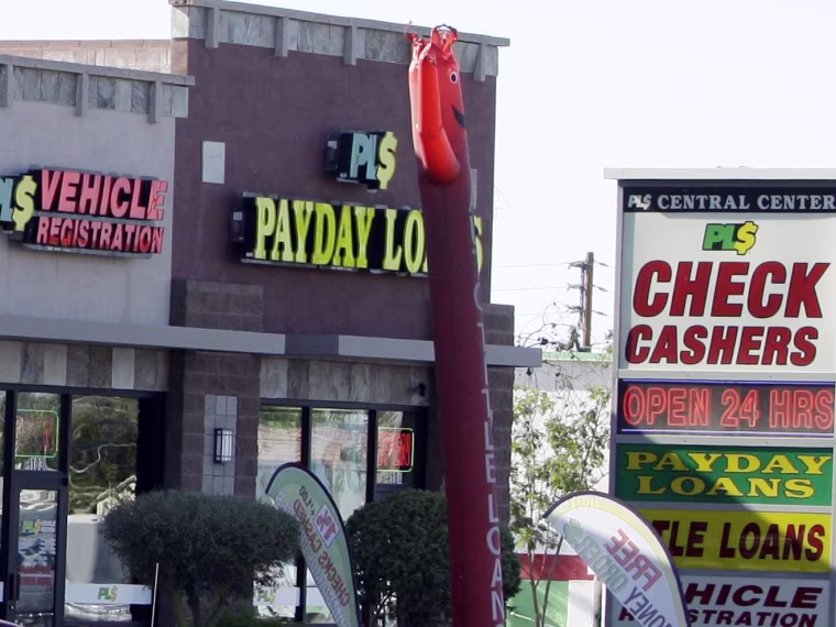 Image: Payday loan businesses advertise their services in Phoenix, Ariz.