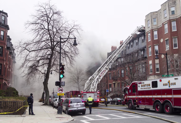 Image: Firefighters fight a multi-alarm fire at a four-story brownstone in the Back Bay neighborhood near the Charles River
