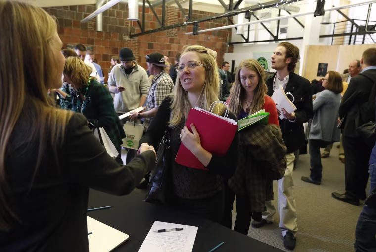 Job seekers attend a marijuana industry job fair hosted by Open Vape, a vaporizer company, in Downtown Denver.