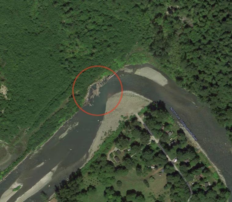A Google Earth satellite image shows the bend in the Stillaguamish River in Oso, Wash., where a retaining wall appears to have broken apart.
