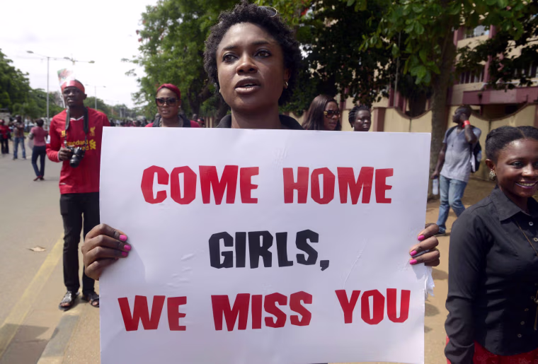 Image: A woman carries placard to press for the release of missing Chibok school girls