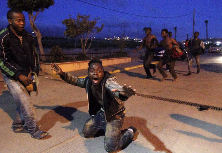 Image: Migrants try to storm Spanish enclave in North Africa