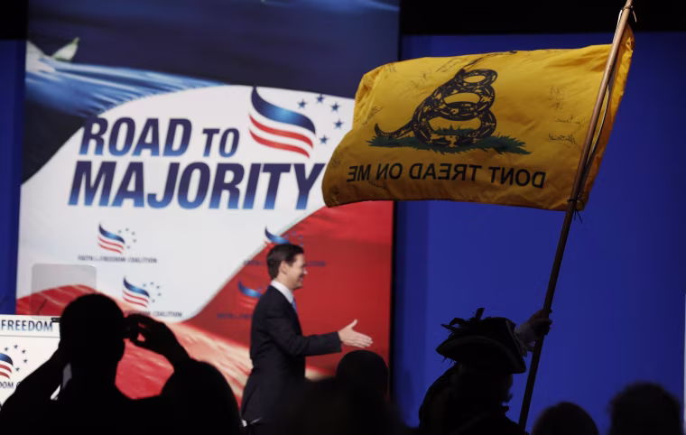 Image: William Temple, from the Golden Isles Tea Party, waves a flag in the audience at the 5th annual Faith & Freedom Coalition's "Road to Majority" Policy Conference in Washington