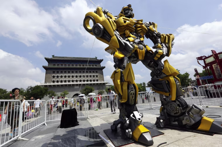 Image: A model of the Transformers character Bumblebee is displayed in front of Qianmen Gate in central Beijing