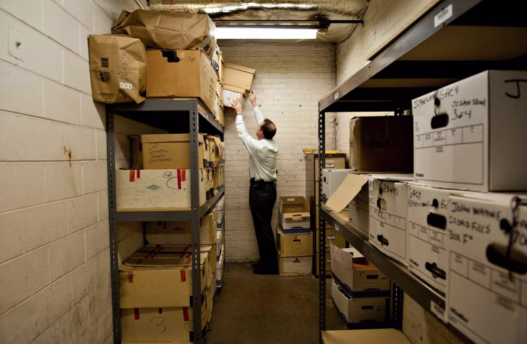 Image: Cook County Sheriff's Detective Jason Moran pulls a box containing evidence