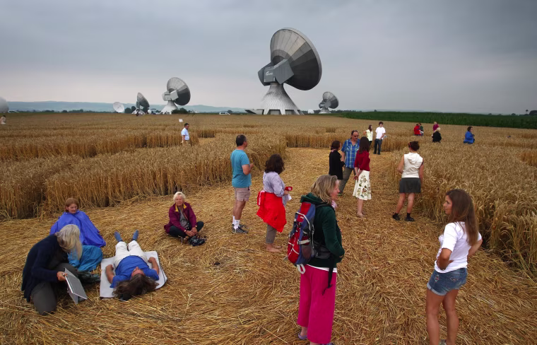 Visitors wandering through a field where crop circles have been found near the satellite earth station in Raisting, Germany.