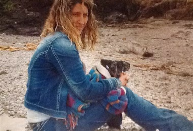 Sandra Miller holds her dog on Glass Beach near Fort Bragg, Calif. in April 2013, a month before she was killed.