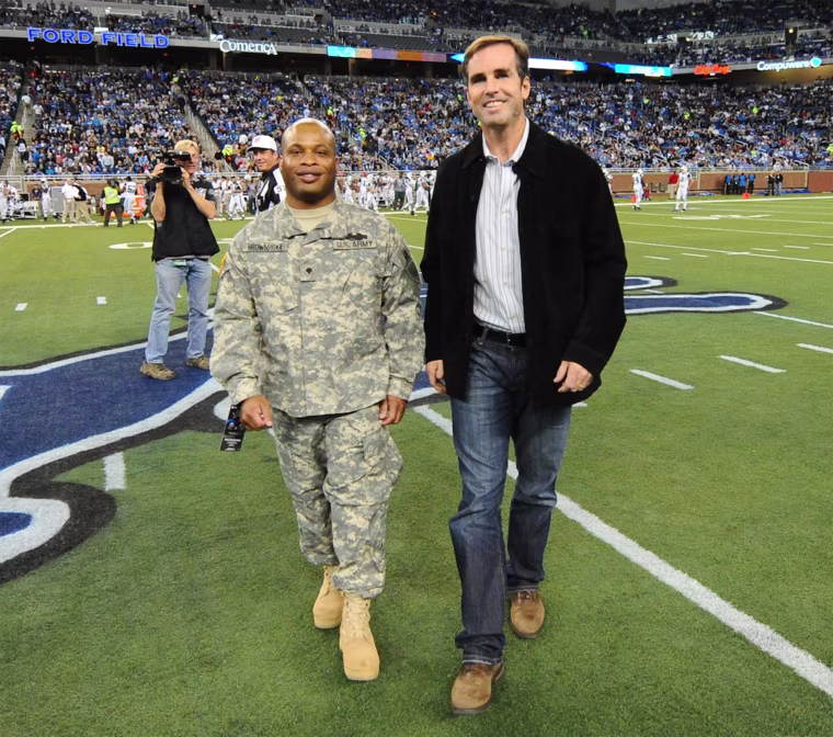 Image: Specialist Ira Brownridge joins Bob Woodruff for the coin toss at Ford Field, on Nov. 22, 2010.