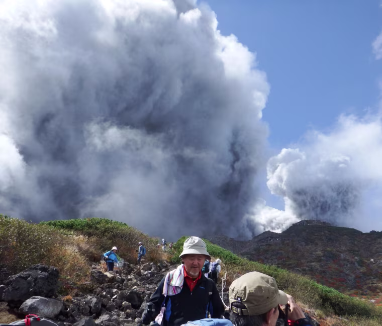 Image: Climbers descend Mt. Ontake, which straddles Nagano and Gifu prefectures, to evacuate as the volcano erupts in central Japan