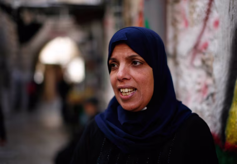 Nahil Salayme, 42, a resident of East Jerusalem, heads home after praying at the Al Aqsa mosque in Jerusalem. She was refused access yesterday after Israeli security forces closed the site yesterday following an attack on a prominent right wing Jewish act