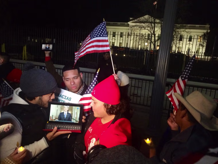 Image: People watch President Barack Obama give a speech on executive action on immigration outside the White House on Thursday, Nov. 20.