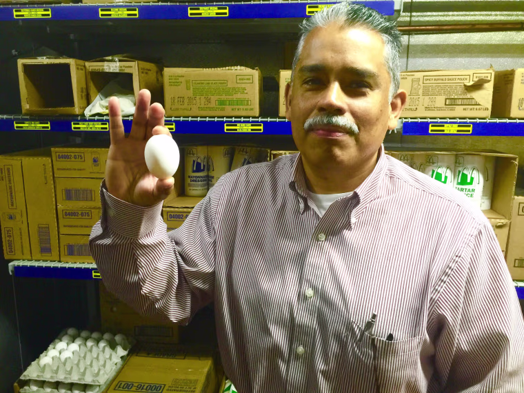 German Ustariz shows one of the fresh eggs used for McDonald's breakfasts. He and his wife Delma own four McDonald's franchises in the greater Austin area. He started working at McDonald's at 16 in Los Angeles, and met his wife while they both worked there. They took a chance as owner-operators, moving to Austin without knowing anyone.