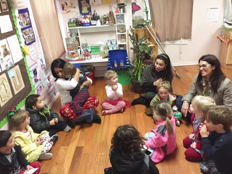 Adriana Rodriguez, second from right, joins her students in a Spanish-language song and lesson.