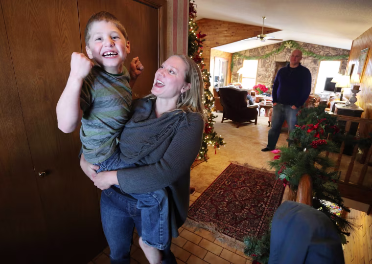 Image: Nichole Gross plays with her son Chase, who is autistic and epileptic, at their home in Colorado Springs, Colo. Chase was moved from Chicago to Colorado so he could legally access a medical marijuana oil known as Charlotte's Web.