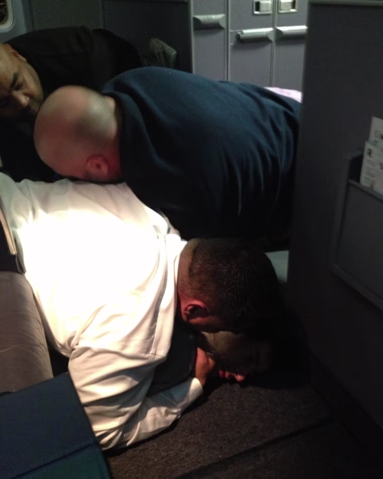 Image: A passenger is restrained  on United Flight 1074 (Dulles -> Denver) returned to Dulles Internation Airport After a passenger failed to comply with crew instructions.